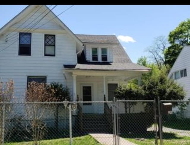 view of front of house with a gate, covered porch, and a fenced front yard