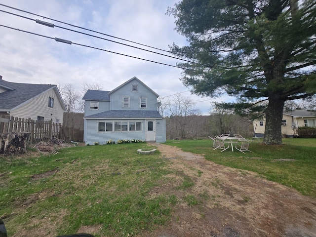 89 Cold Spring Rd, Monticello, NY 12701 - rear view of house featuring roof with shingles, a yard, and fence