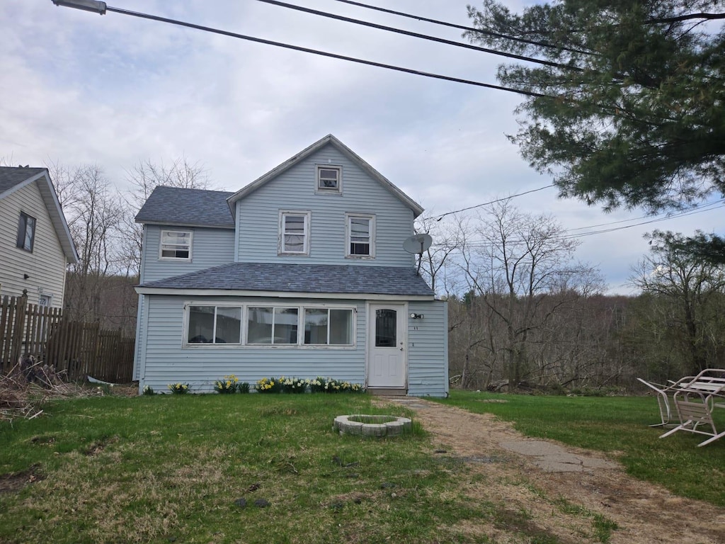 89 Cold Spring Rd, Monticello, NY 12701 - rear view of house featuring a lawn, fence, and a shingled roof