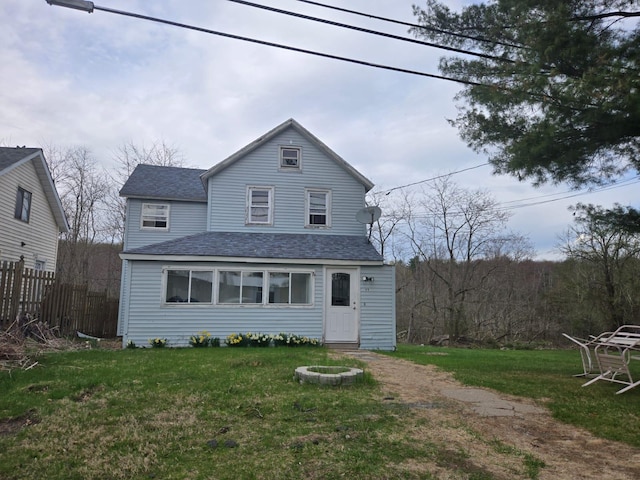 89 Cold Spring Rd, Monticello, NY 12701 - rear view of house featuring a lawn, fence, and a shingled roof