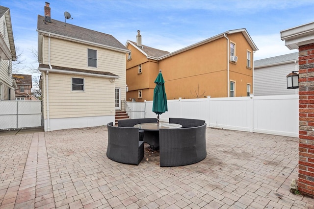 89-21 Aubrey Ave, Glendale, NY 11385 - view of patio featuring fence, outdoor dining area, and cooling unit