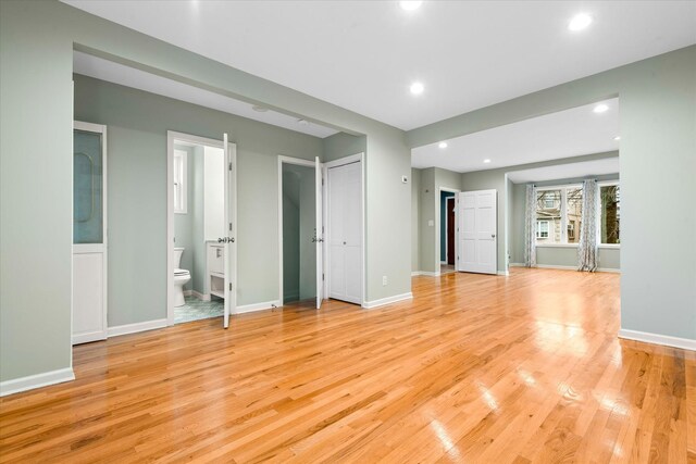89-21 Aubrey Ave, Glendale, NY 11385 - unfurnished living room with light wood-style flooring, recessed lighting, and baseboards