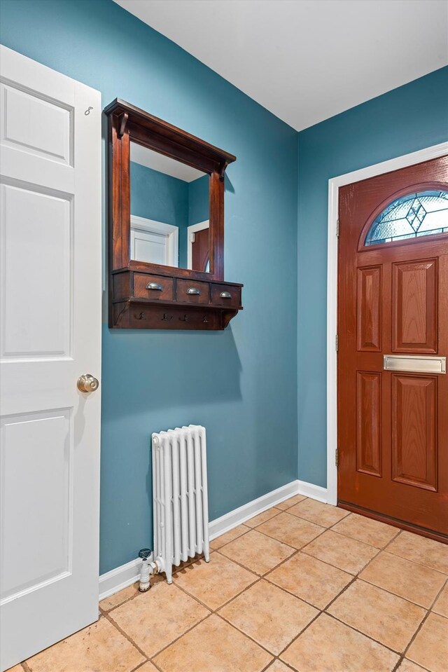 89-21 Aubrey Ave, Glendale, NY 11385 - foyer entrance featuring radiator, tile patterned flooring, and baseboards
