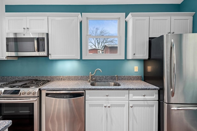 89-21 Aubrey Ave, Glendale, NY 11385 - kitchen featuring stainless steel appliances, a sink, white cabinets, and stone countertops