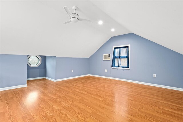 89-21 Aubrey Ave, Glendale, NY 11385 - bonus room with light wood-style flooring, a wall unit AC, lofted ceiling, a ceiling fan, and baseboards