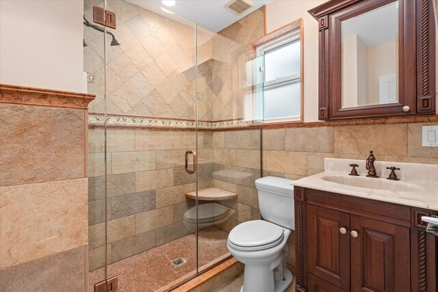 89-21 Aubrey Ave, Glendale, NY 11385 - bathroom with tile walls, toilet, vanity, and a shower stall