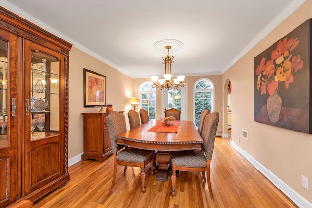 355 Divot Rd, Oceanside, NY 11572 - dining area with light wood-type flooring, visible vents, ornamental molding, and an inviting chandelier
