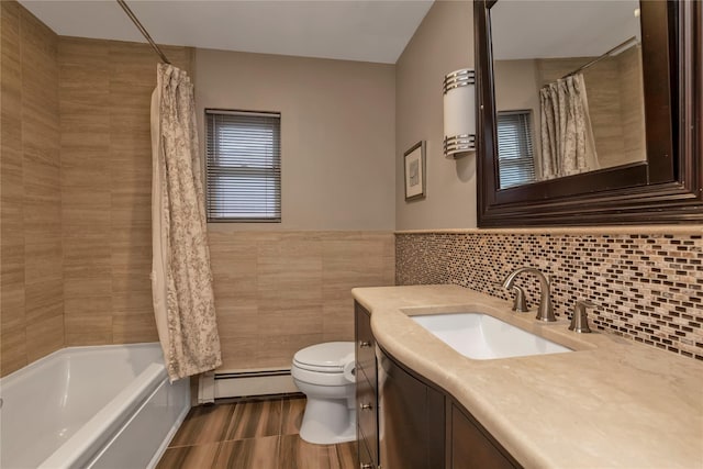 355 Divot Rd, Oceanside, NY 11572 - full bath with shower / bathtub combination with curtain, toilet, a baseboard heating unit, tile walls, and vanity