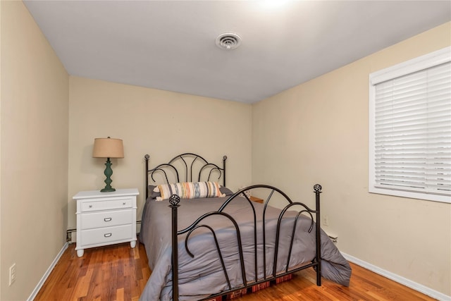 355 Divot Rd, Oceanside, NY 11572 - bedroom featuring visible vents, baseboards, and wood finished floors