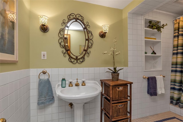 355 Divot Rd, Oceanside, NY 11572 - bathroom with tile walls, a shower with curtain, and wainscoting