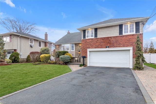355 Divot Rd, Oceanside, NY 11572 - tri-level home featuring fence, an attached garage, a front lawn, aphalt driveway, and brick siding