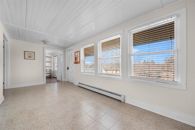 empty room with light tile patterned flooring, baseboard heating, wooden ceiling, and baseboards