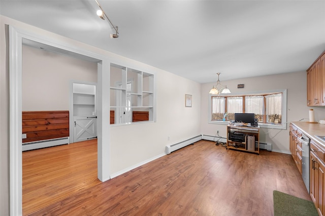 kitchen featuring baseboard heating, light wood-style flooring, dishwasher, and an inviting chandelier