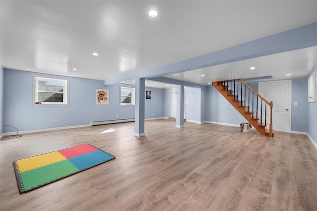 workout room with recessed lighting, light wood-style flooring, and a baseboard radiator