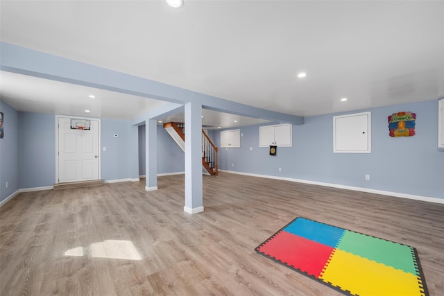 exercise area featuring recessed lighting, baseboards, and wood finished floors