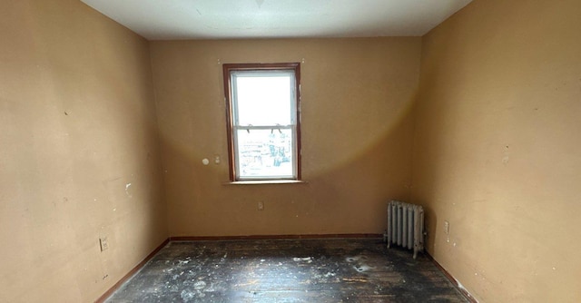 181-10 93rd Ave, Hollis, NY 11423 - unfurnished room with baseboards, radiator heating unit, and a healthy amount of sunlight