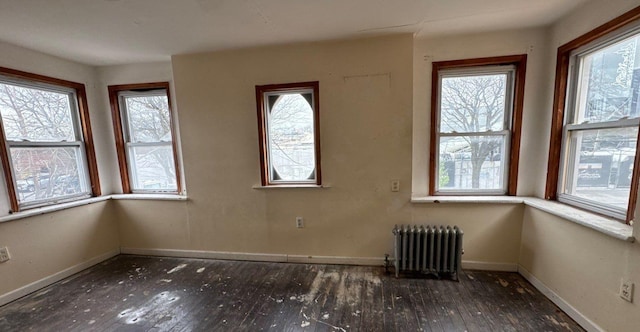 181-10 93rd Ave, Hollis, NY 11423 - interior space featuring baseboards, radiator, a wealth of natural light, and hardwood / wood-style floors