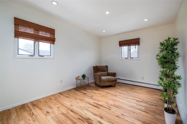 unfurnished room with recessed lighting, baseboards, baseboard heating, and light wood-style floors