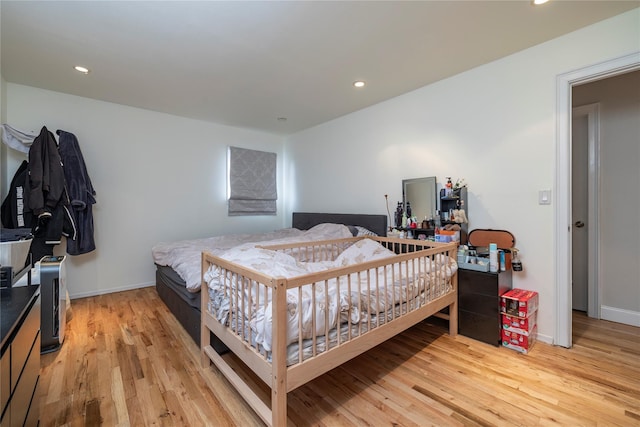 bedroom featuring recessed lighting, light wood-style flooring, and baseboards