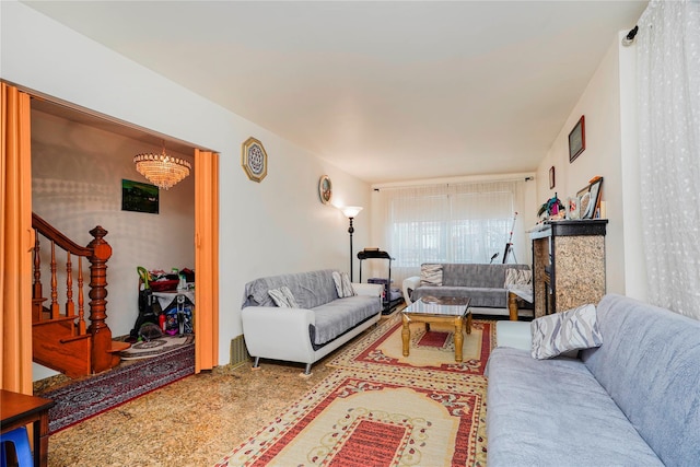 living room with stairway and a notable chandelier