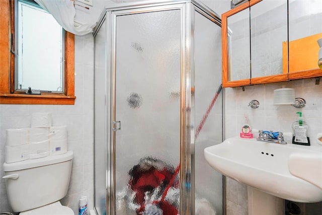 full bathroom with a sink, tile walls, and a stall shower
