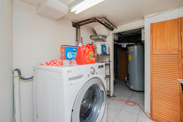 clothes washing area with washer / dryer, gas water heater, light tile patterned floors, and laundry area