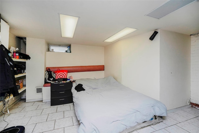 bedroom featuring light tile patterned floors and visible vents