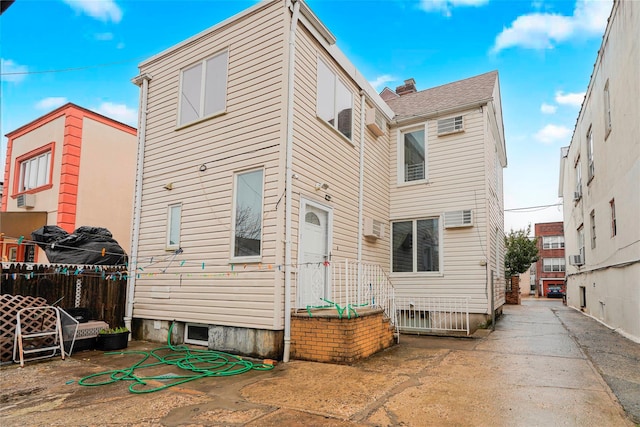 rear view of property with fence