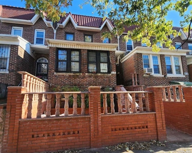 view of property with brick siding and cooling unit