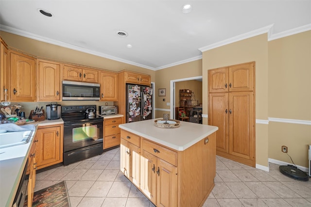 kitchen featuring light countertops, crown molding, light tile patterned floors, a kitchen island, and black appliances