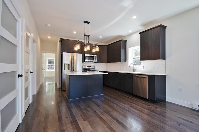 1211 Gulf Rd, Livingston Manor, NY 12724 - kitchen with appliances with stainless steel finishes, dark brown cabinets, light countertops, dark wood finished floors, and decorative backsplash