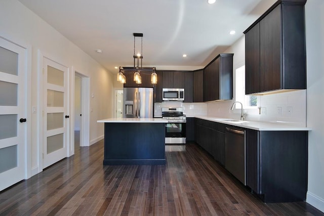 1211 Gulf Rd, Livingston Manor, NY 12724 - kitchen with appliances with stainless steel finishes, decorative backsplash, a kitchen island, light countertops, and dark wood-style flooring