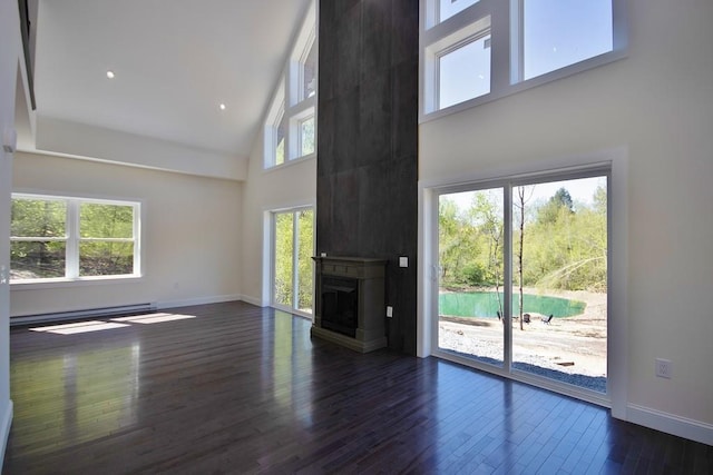 1211 Gulf Rd, Livingston Manor, NY 12724 - unfurnished living room featuring a baseboard heating unit, high vaulted ceiling, wood finished floors, and a fireplace