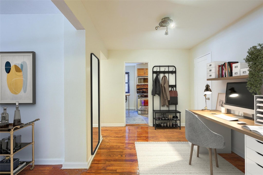 102-25 67th Rd Unit 2C, Forest Hills, NY 11375 - home office with built in study area, baseboards, and wood finished floors