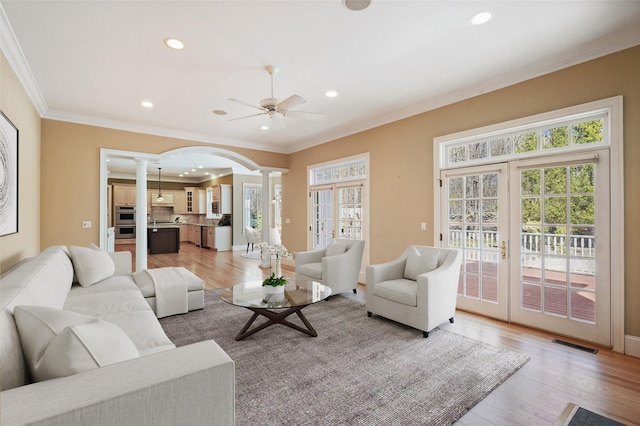 living area with recessed lighting, a ceiling fan, decorative columns, and ornamental molding