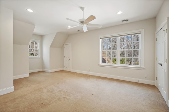 additional living space with recessed lighting, baseboards, and light colored carpet