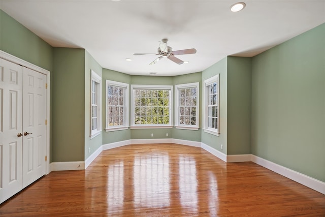 interior space featuring baseboards, wood finished floors, and a closet