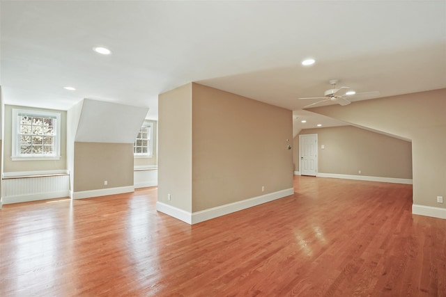 bonus room with ceiling fan, a healthy amount of sunlight, and light wood-style floors