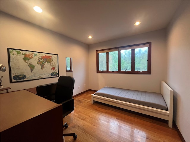 bedroom featuring recessed lighting, baseboards, and light wood-type flooring
