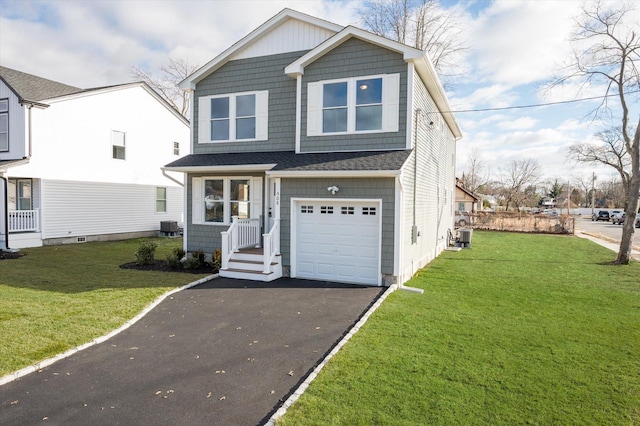 98 S 36th St, Wyandanch, NY 11798 - view of front of property with central air condition unit, driveway, a front yard, and an attached garage