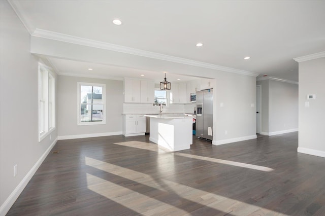 98 S 36th St, Wyandanch, NY 11798 - unfurnished living room featuring dark wood-style floors, recessed lighting, crown molding, and baseboards