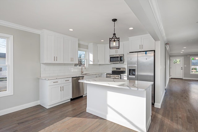 98 S 36th St, Wyandanch, NY 11798 - kitchen featuring plenty of natural light, stainless steel appliances, white cabinets, crown molding, and decorative backsplash