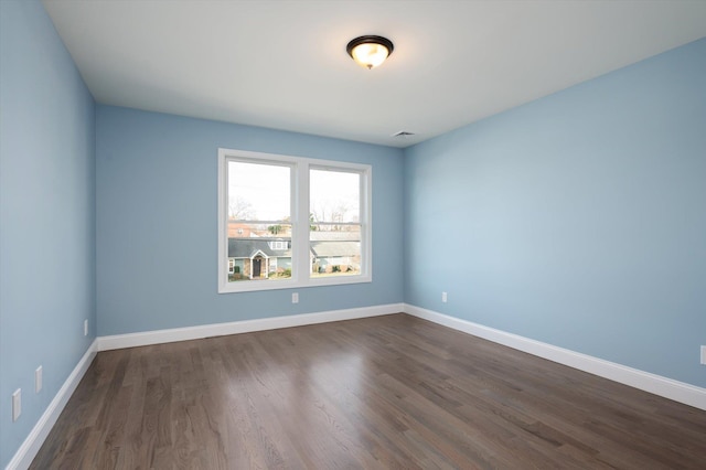 98 S 36th St, Wyandanch, NY 11798 - spare room with visible vents, baseboards, and dark wood finished floors