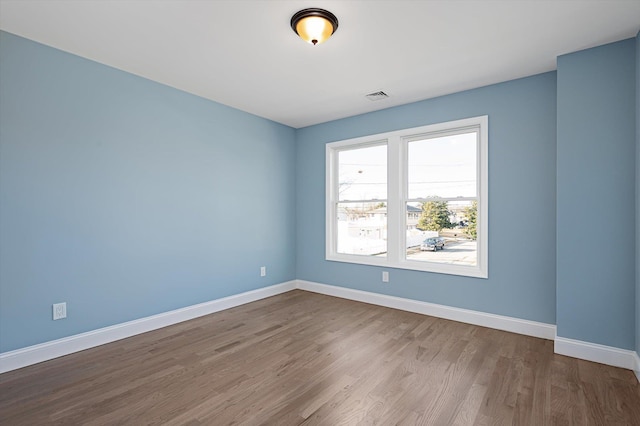 98 S 36th St, Wyandanch, NY 11798 - spare room featuring visible vents, baseboards, and wood finished floors