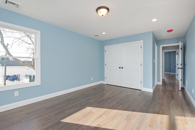 98 S 36th St, Wyandanch, NY 11798 - unfurnished bedroom featuring visible vents, baseboards, and wood finished floors