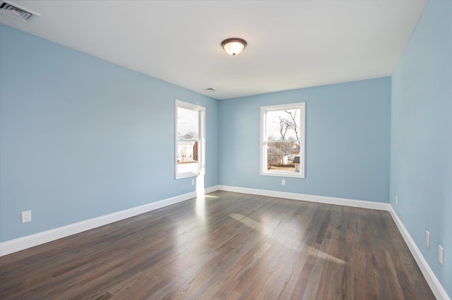 98 S 36th St, Wyandanch, NY 11798 - spare room featuring dark wood-style floors, visible vents, and baseboards