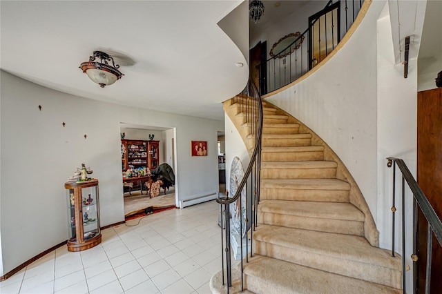 staircase featuring tile patterned floors and baseboard heating