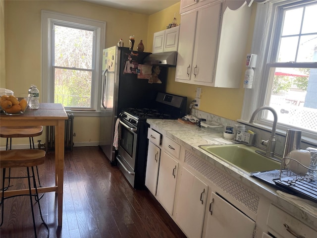 248-29 88th Rd, Bellerose, NY 11426 - kitchen featuring gas range, white cabinets, and a wealth of natural light