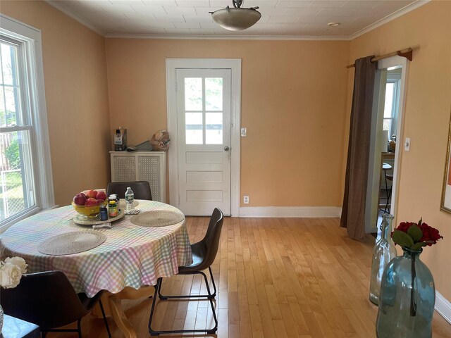 248-29 88th Rd, Bellerose, NY 11426 - dining area with baseboards, light wood finished floors, and crown molding
