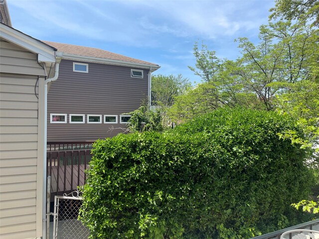 248-29 88th Rd, Bellerose, NY 11426 - view of side of home featuring roof with shingles